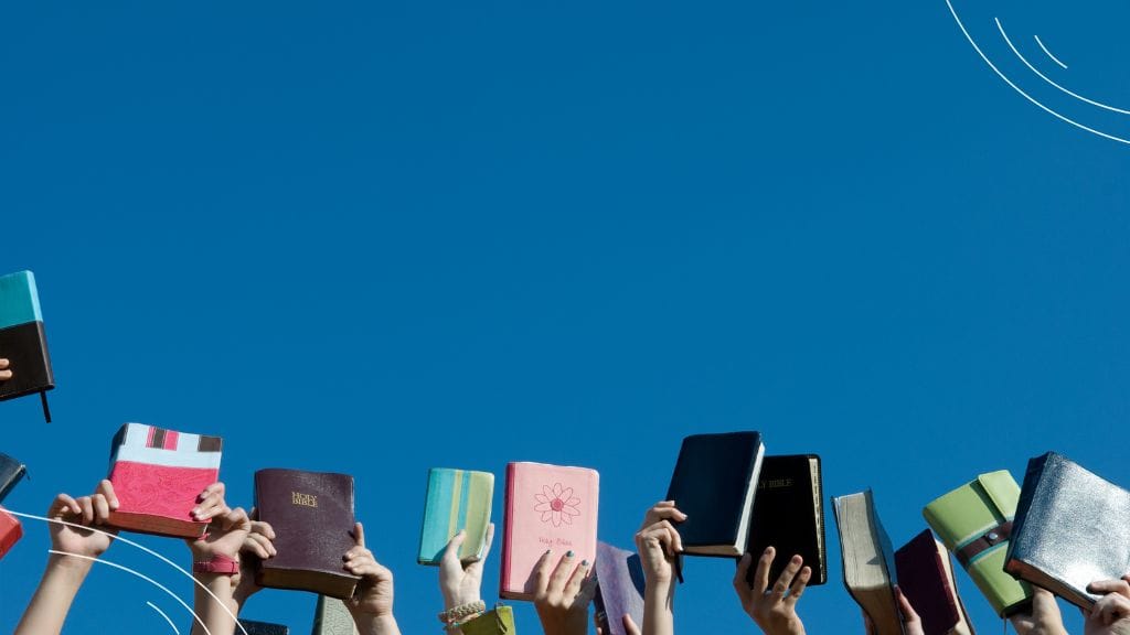 Bible Reading Plan for Beginners (5) peoples arms holding up Bibles against a blue sky