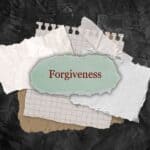 forgiveness written on a stack of ripped sheets of paper - Bible verses about forgiving